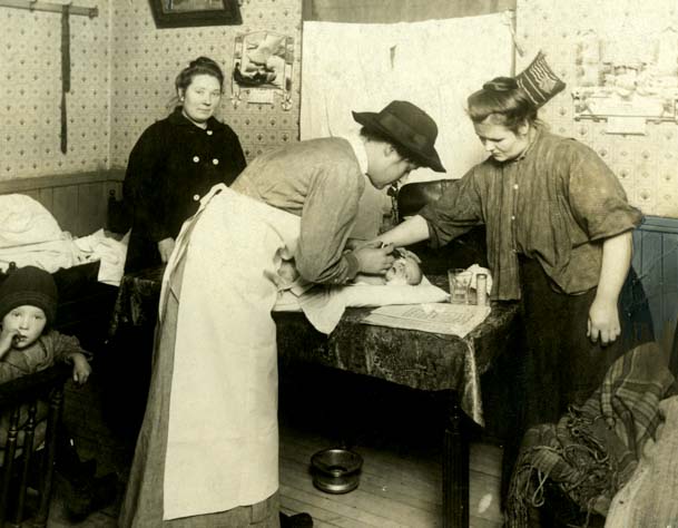 A Visiting Nurse From Henry Street Settlement Treats An Infant In A Tenement Apartment